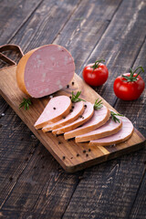 Fresh sausages and ham slices on wooden cutting board, delicious snack, spicy and high quality meat...