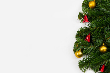 Christmas tree decorations background with copy space, red bell and gold ornament on white background