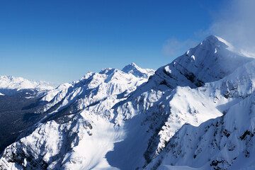 Plakat Snow-capped mountain peaks. Natural background. Ski resort Caucasus Mountains nature and sports.