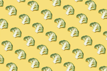 Fresh raw green broccoli on a yellow background. Healthy food creative concept. Diet organic foods healthy lifestyle. Summer vegetable background.