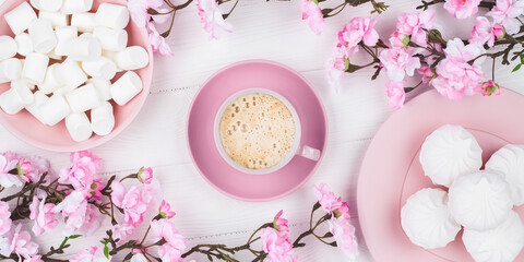 Romantic spring still life. Coffee cup with marshmallow in the morning for breakfast. Cherry...