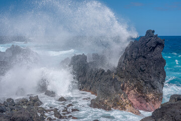 USA, Hawaii, Big Island of Hawaii. Laupahoehoe Point Beach Park, Incoming waves crash onto rough volcanic rock.