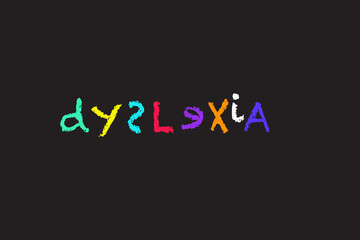 dyslexia spelled in coloured chalk letters on a blackboard - obrazy, fototapety, plakaty