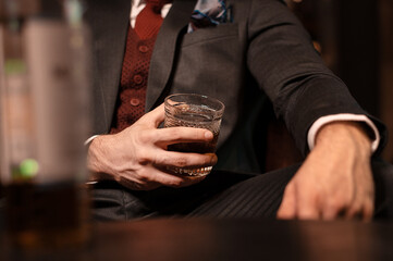 man with a glass of whiskey