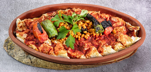 close up of Turkish Beyti Kebap garnished with vegetables on a wooden tray - Turkish, Arabian Food Kebab