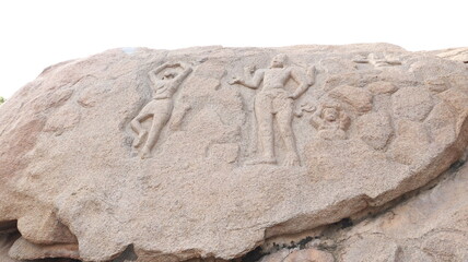 Arjuna's penance - ancient. Statues carved into the wall of the Mahabalipuram rock. The rock wall is located in the background.