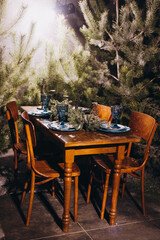 Christmas decorated dinner table in forest. Winter photo zone.