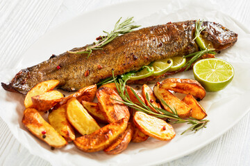 baked trout fish with roast potatoes, top view