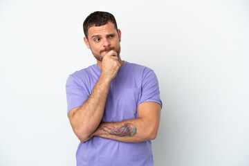 Young Brazilian man isolated on white background having doubts and thinking