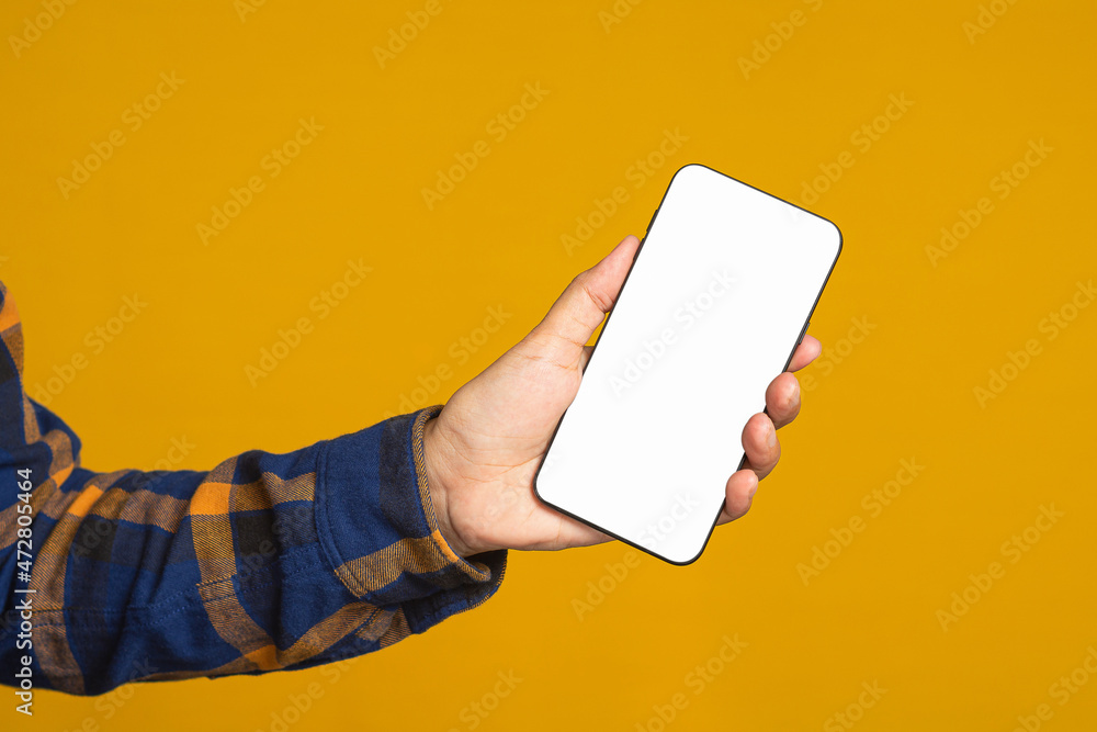 Poster technology, communication, and advertising concept. close-up of hand holding a mobile phone with bla