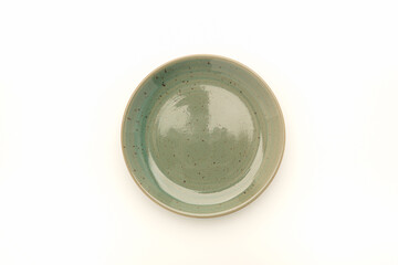 Top view of an empty green ceramic plate isolated on a white background