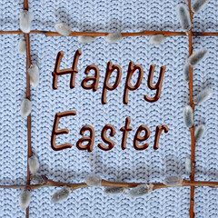 spring easter frame with willow twigs on a knitted blue background, mock up for design, free space for text