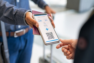 Man showing digital flight e-ticket to stewardess