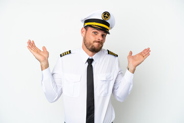 Airplane Brazilian pilot isolated on white background having doubts while raising hands
