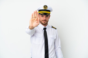 Airplane Brazilian pilot isolated on white background making stop gesture