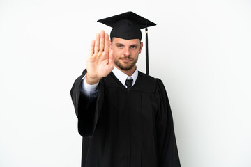 Young university Brazilian graduate isolated on white background making stop gesture