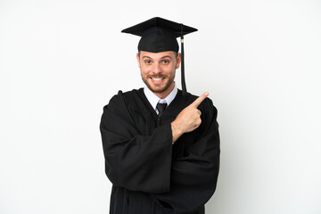 Young university Brazilian graduate isolated on white background pointing to the side to present a product