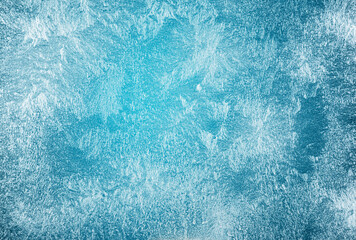 Frost patterns on frozen winter window as a symbol of Christmas wonder. Christmas or New year background.