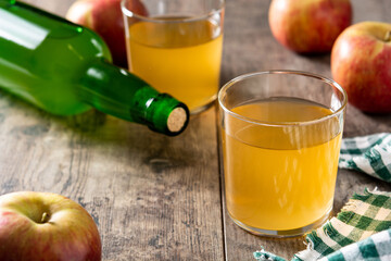 Apple cider drink on rustic wooden table. Copy space