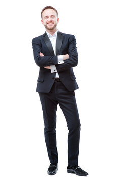 Confidence and charisma. Full length of young businessman in suit keeping arms crossed and looking at camera isolated on white background