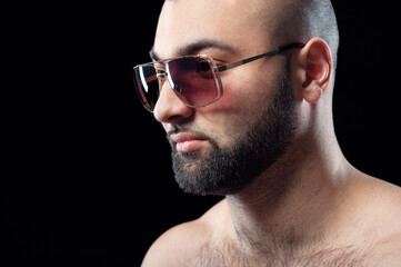 Strong latino man with beard in sunglasses.