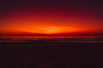 Fototapeta premium Colorful red bright sky with sunset or sunrise at beach