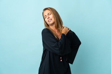 Middle age brazilian woman isolated on blue background suffering from pain in shoulder for having...