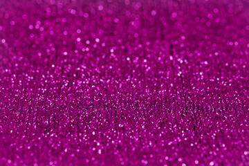 Blurred purple bokeh of knitted material.Holliday background