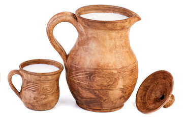 Clay jug and cup of milk isolated on a white background