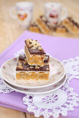 Homemade waffle dessert with chocolate, biscuits and nuts