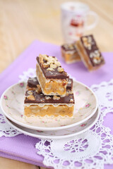 Homemade waffle dessert with chocolate, biscuits and nuts