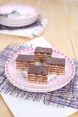 Homemade waffle dessert with chocolate, biscuits and nuts