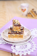 Homemade waffle dessert with chocolate, biscuits and nuts