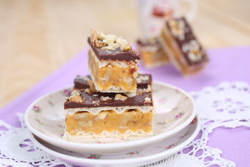 Homemade waffle dessert with chocolate, biscuits and nuts