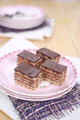 Homemade waffle dessert with chocolate, biscuits and nuts