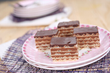 Homemade waffle dessert with chocolate, biscuits and nuts