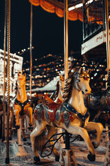 Fototapeta na wymiar Festive children's Merry Go Round Carousel fun in the New Year atmosphere. Vertical magic poster