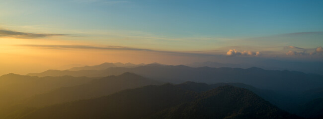 Fototapeta na wymiar Panoramic beautiful sunrise landscape from the forest in the national park on top mountain, Thailand.