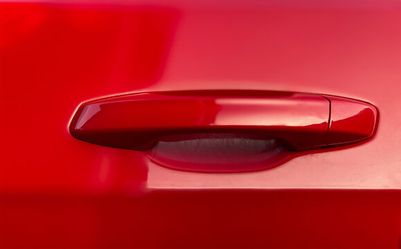 Close-up handle from red car door. Car details