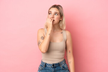 Young caucasian woman isolated on pink background is a little bit nervous