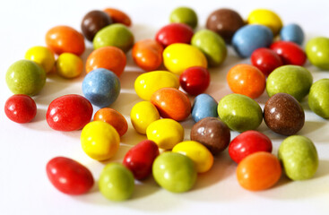 Colorful sweet nuts on white background
