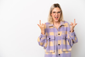 Young caucasian woman isolated on white background making horn gesture