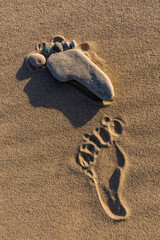 Fototapeta na wymiar Stones on sandy beach that resemble a human foot, Upper Peninsula of Michigan.
