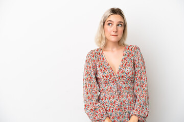 Young caucasian woman isolated on white background having doubts while looking up