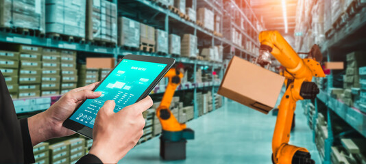 Smart robot arm systems for innovative warehouse and factory digital technology . Automation manufacturing robot controlled by industry engineering using IOT software connected to internet network .