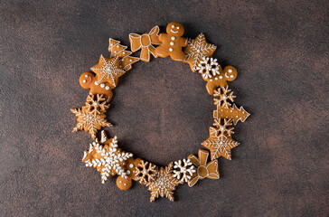 Gingerbread cookies wreath on brown background, Top view