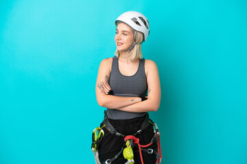 Young caucasian rock-climber woman isolated on white background looking side