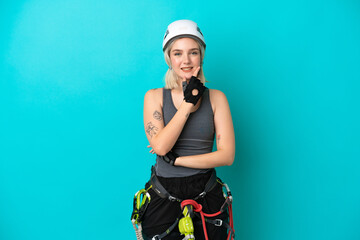 Young caucasian rock-climber woman isolated on white background smiling