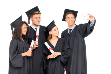 Happy graduates. Group of young attractive students taking selfie together. Isolated on white.