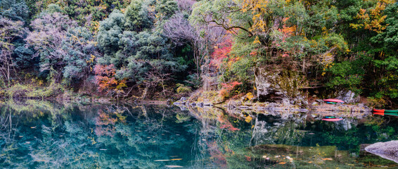 Autumn landscape beautiful colour trees over the river glowing in the sunlight. wonderful background. mountain reflection water in Japan. fresh and cold water